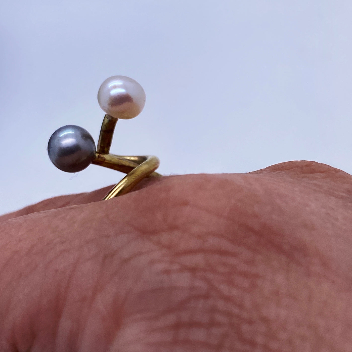 Brass multi volumes ring with grey and white pearls.
