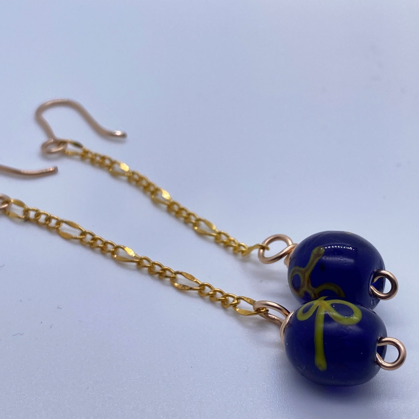 Shake and move earrings with hand inlaid wound Java blue and yellow glass