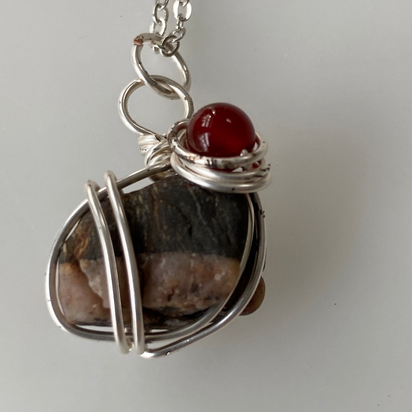 Small beautiful white and black natural stone pendant with red natural stone and silver wire