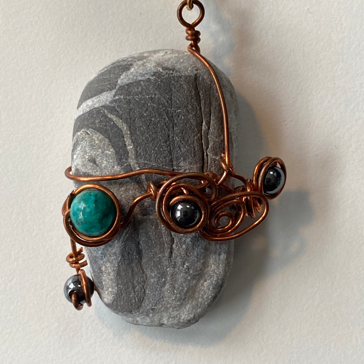 Grey natural stone, hematite, turquoise and  wire pendant