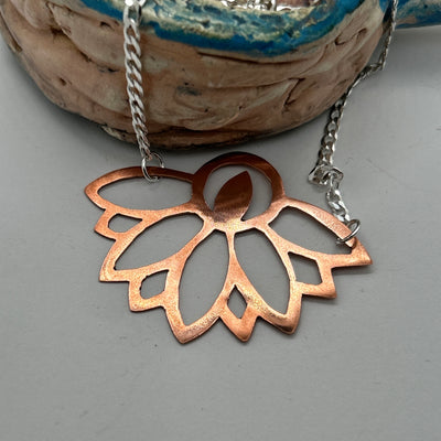 Copper perforated abstract design on silver chain