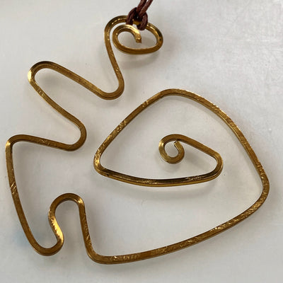 Abstract brass pendant on thin adjustable cord variant 2