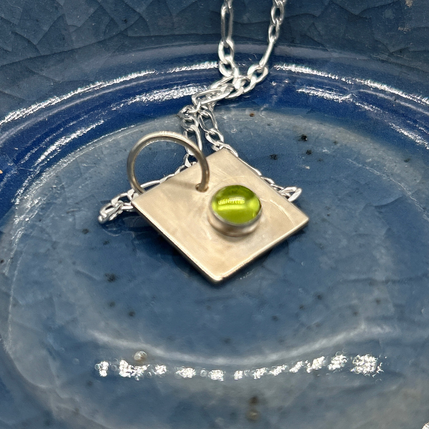 Peridot cabochon 6 mm on silver square pendant mounted on silver chain