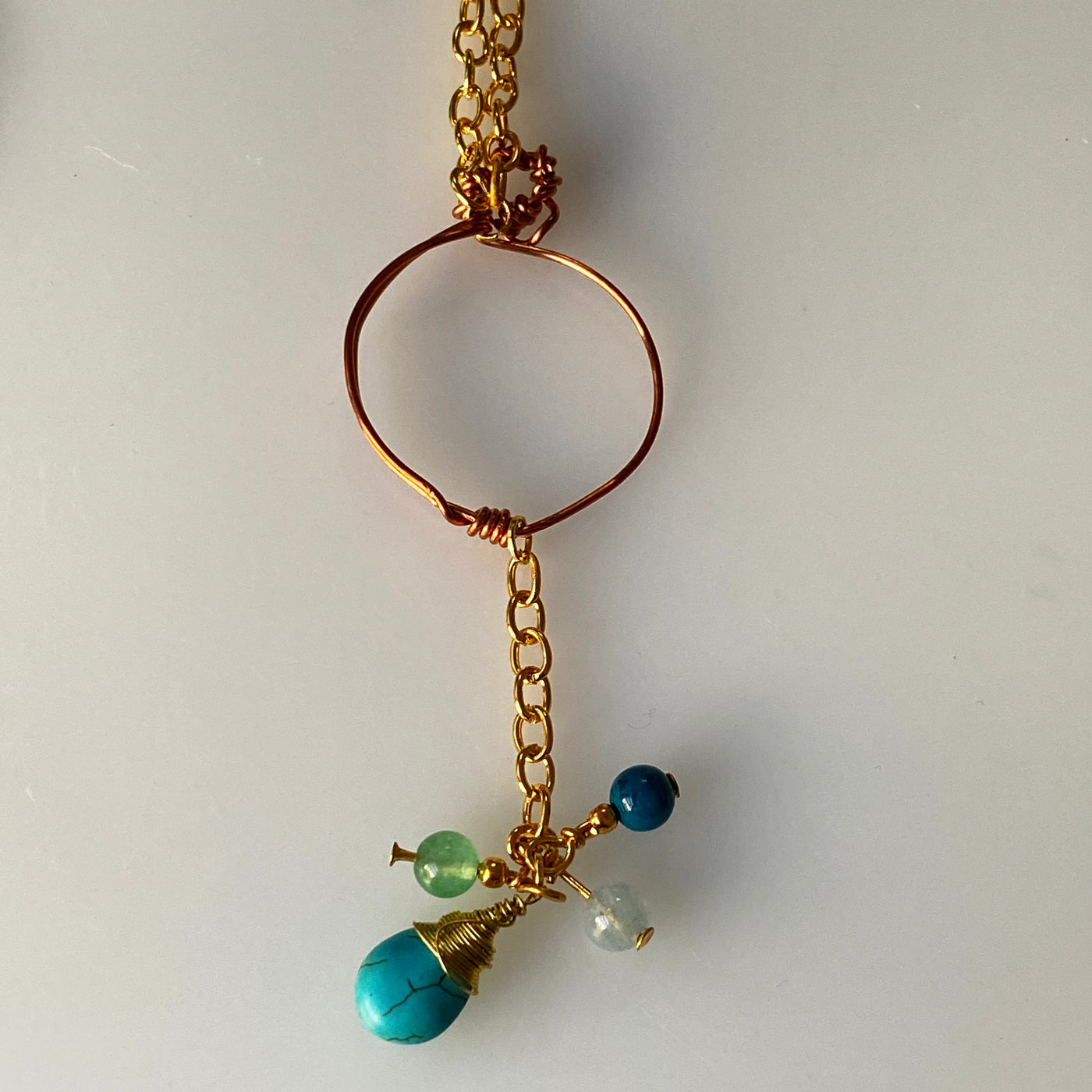 Briolette de perles de howlite bleu tourquoise naturelle, aigue-marine, crysocolle, aventurine et pendentif en fil de fer. Ce pendentif mesure environ 8 cm de long.