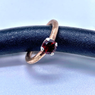 Garnet ring. This ring is made of brass and silver and features a gorgeous 6 mm round garnet. Size N
