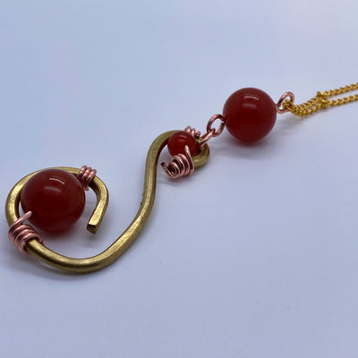 Big brass pendant s shaped with small and big red agate