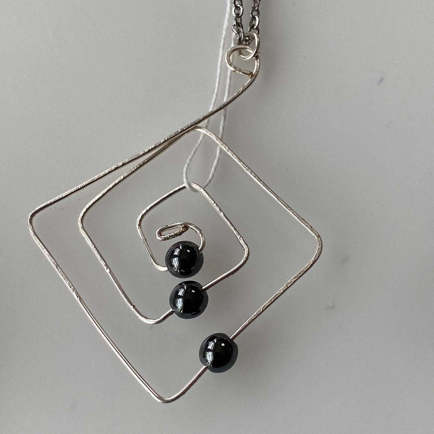 Hematite and silver wire lines collection pendant.