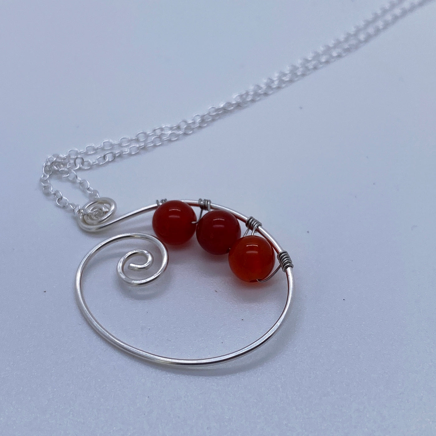 Silver small pendant with wire and red agate