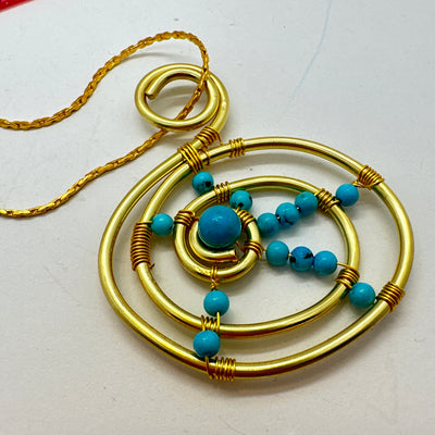 Turquoise and brass round pendant