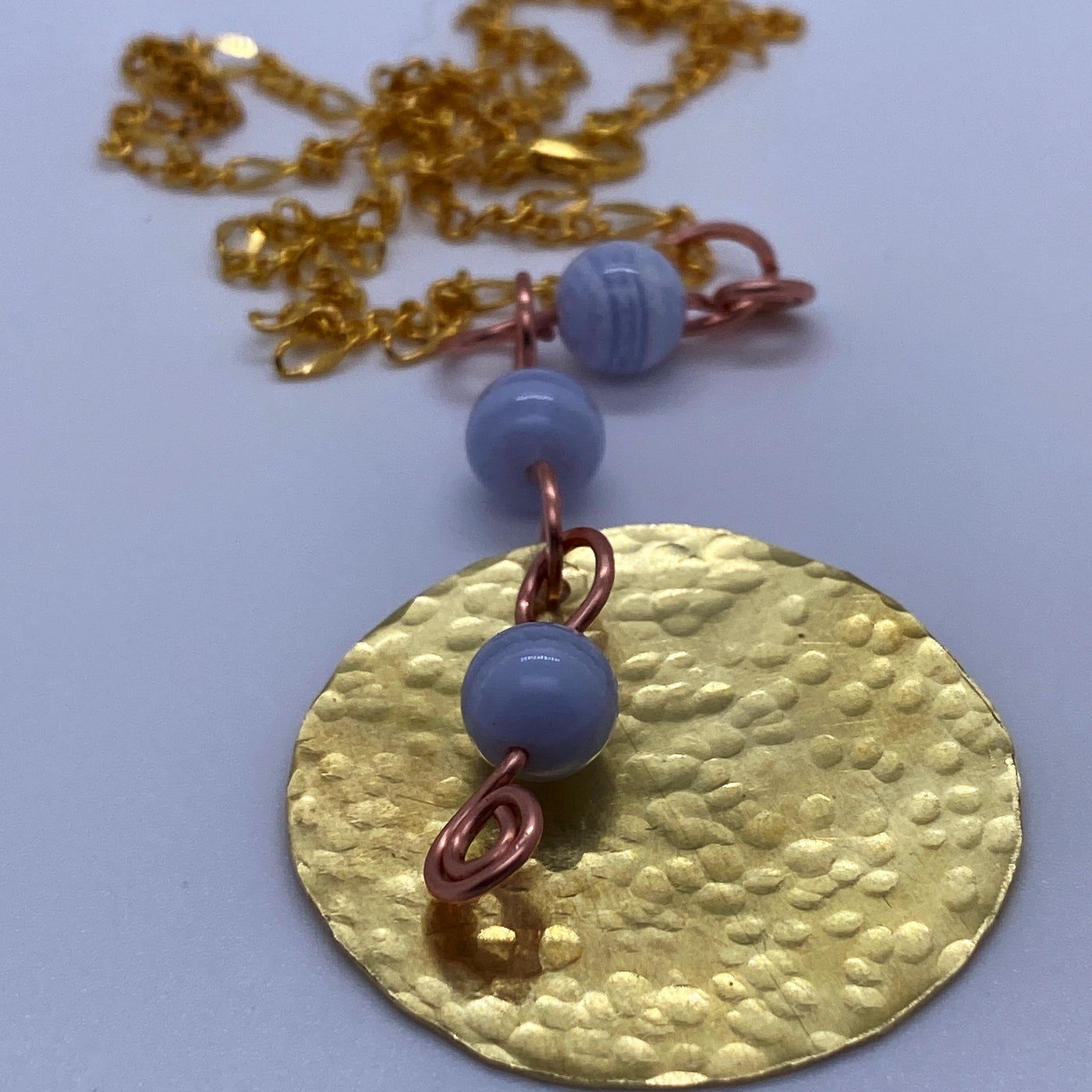 Blue agate and brass central round pendant