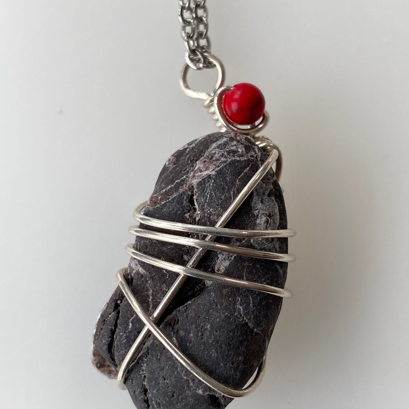 Black natural stone, carnelian and silver wire small pendant.