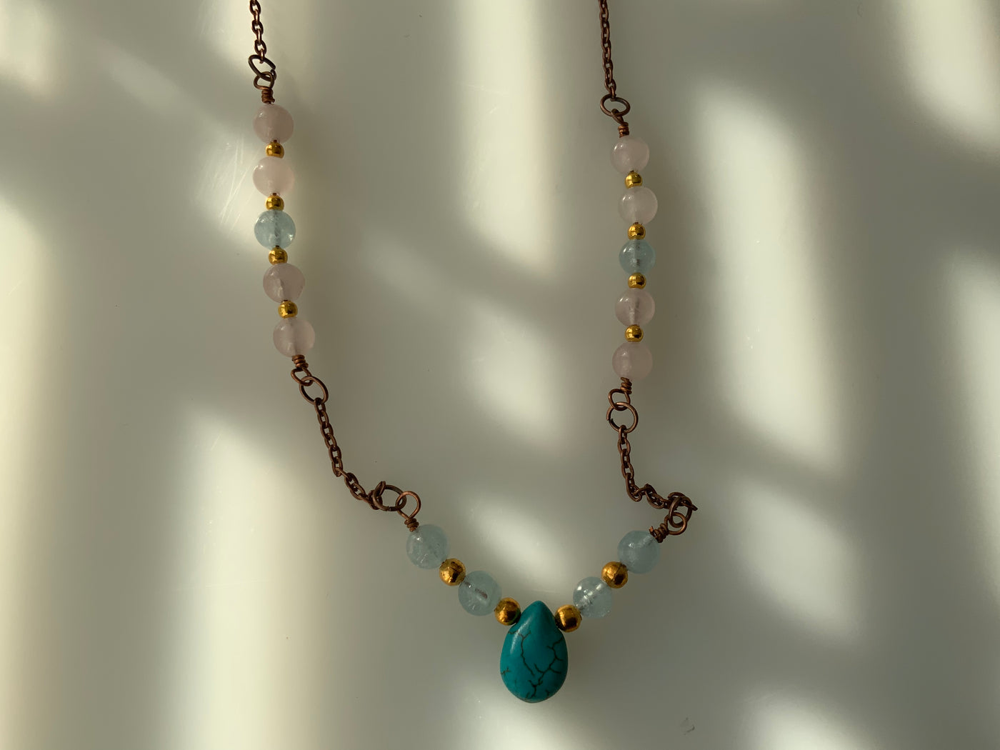 Blue howlite briolette, acquamarine, and rose quartz in chain necklace.
