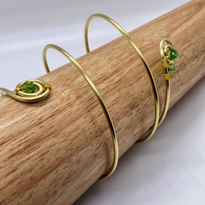 Long spiral brass bracelet with green crystal rondelles