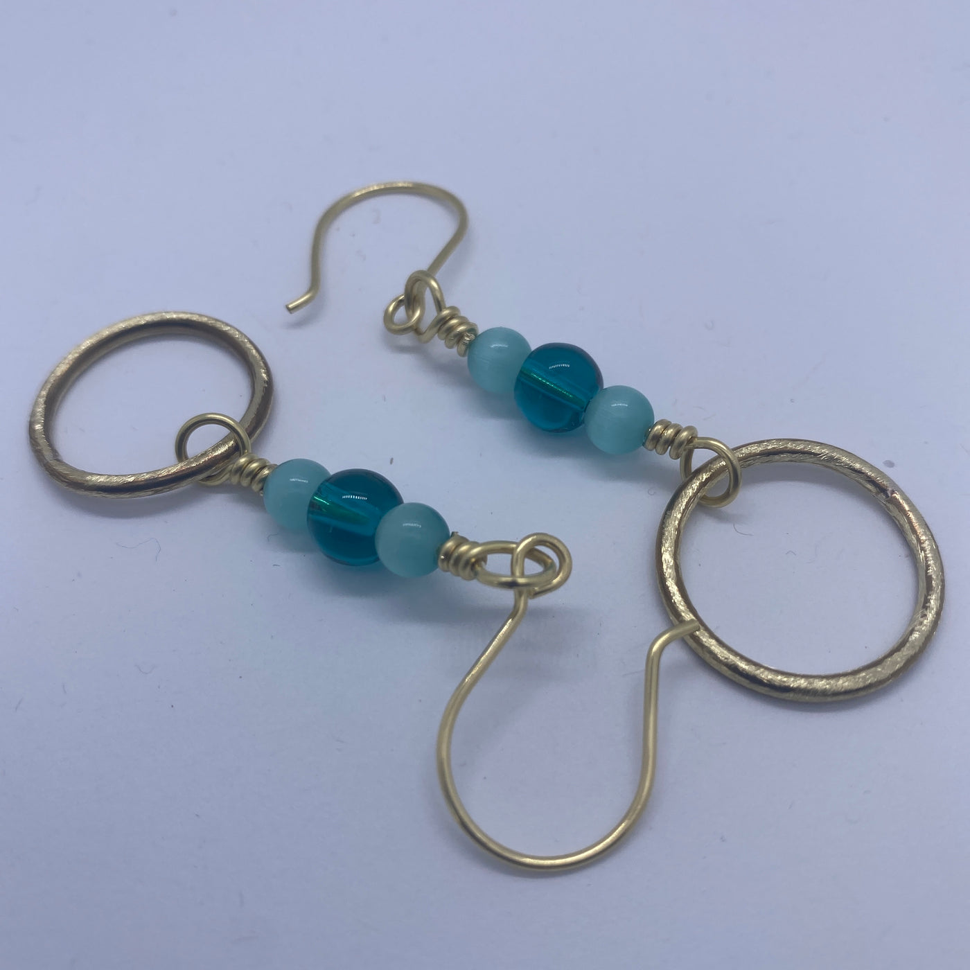 Handmade brass circles with ocean blue round glass 8 mm and 6 mm celeste blue cat eye earrings