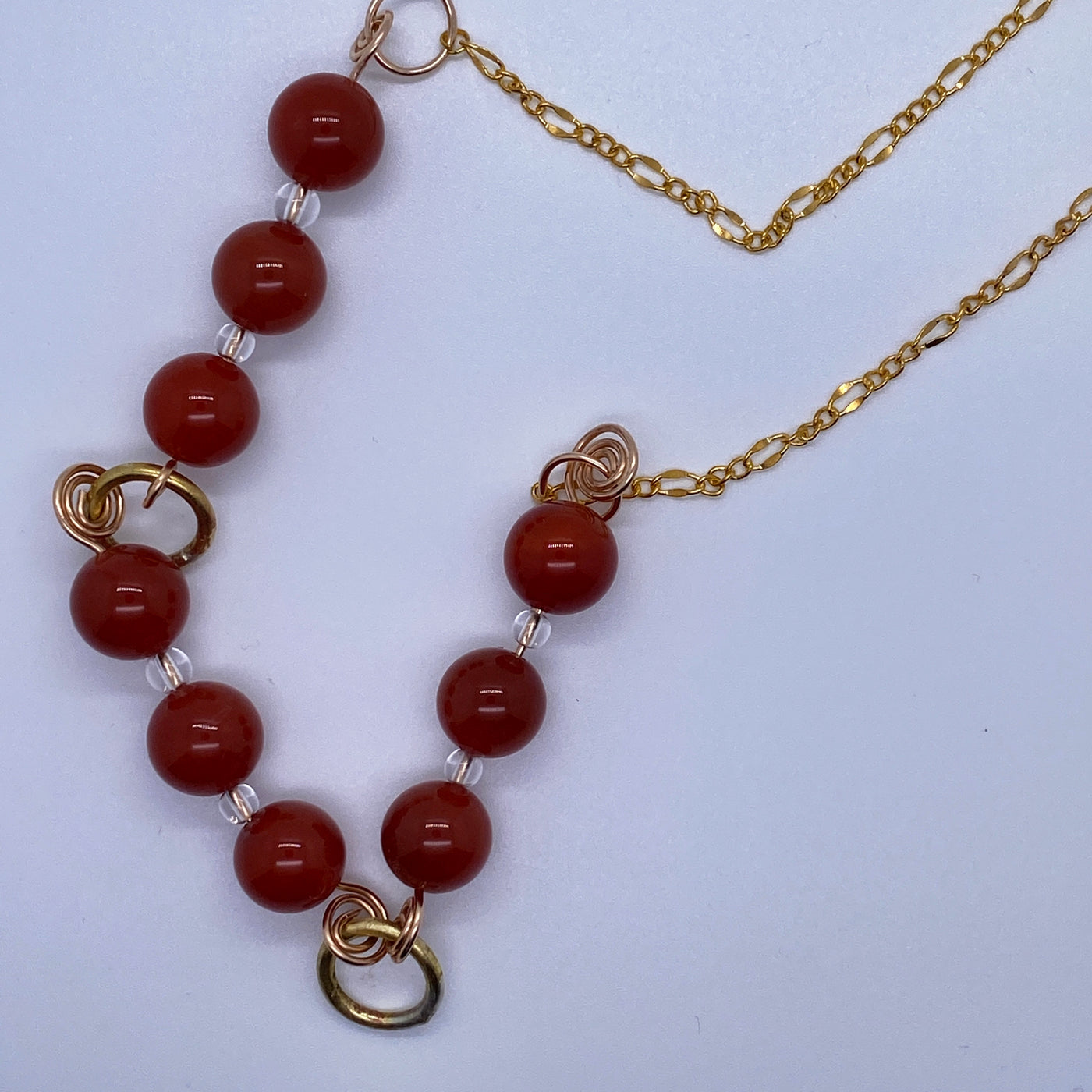 Necklace with red agate, clear quartz and small circles in brass
