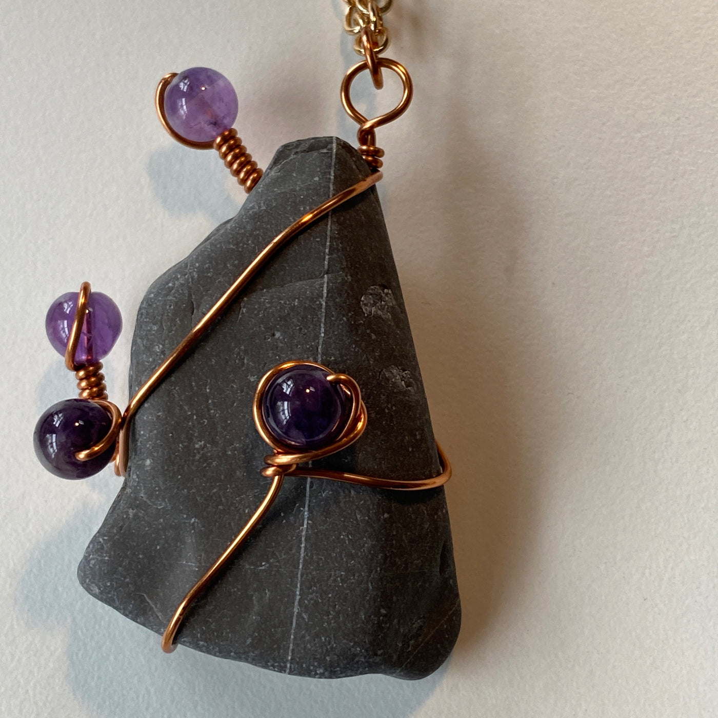 Grey natural stone, amethyst and wire pendant.