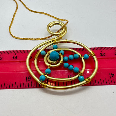 Turquoise and brass round pendant