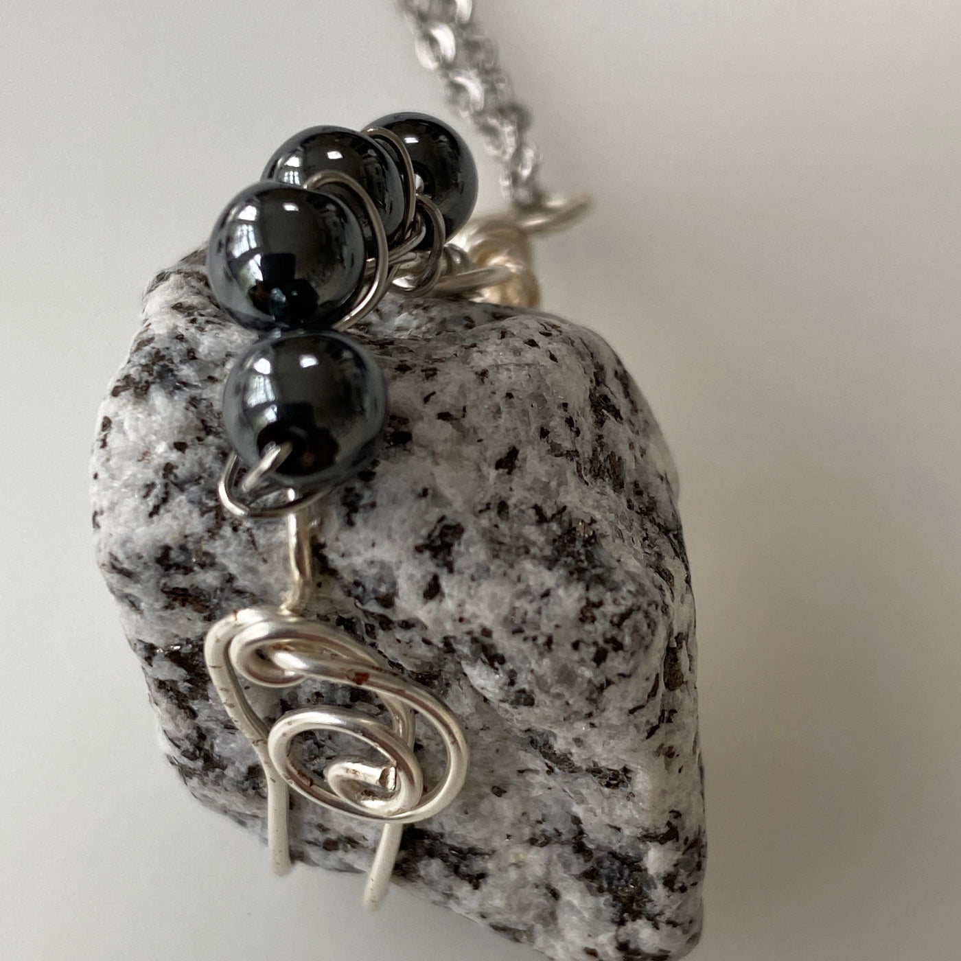 White and black natural stone, hematite and silver wire heavy pendant.