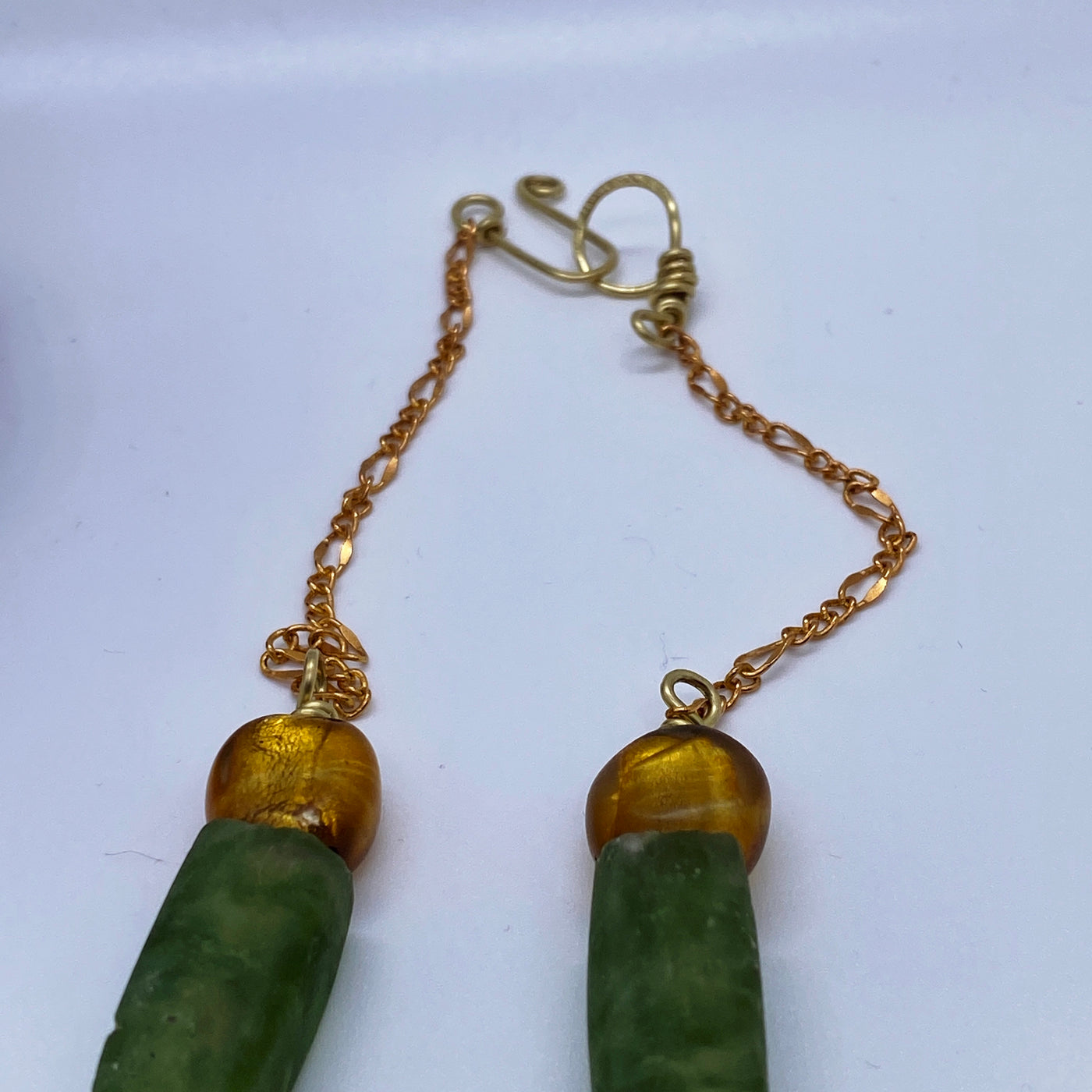 Golden and green glass on chain