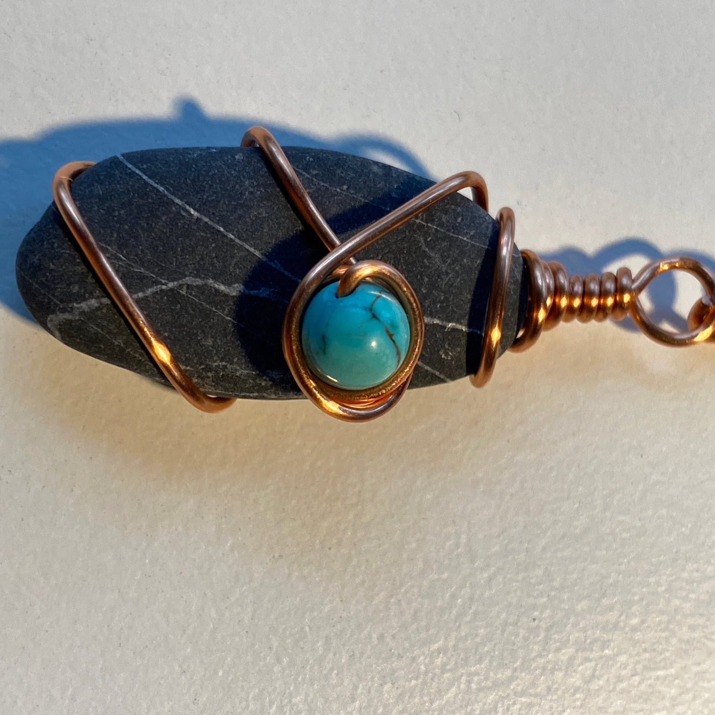 Black stone, turquoise and wire