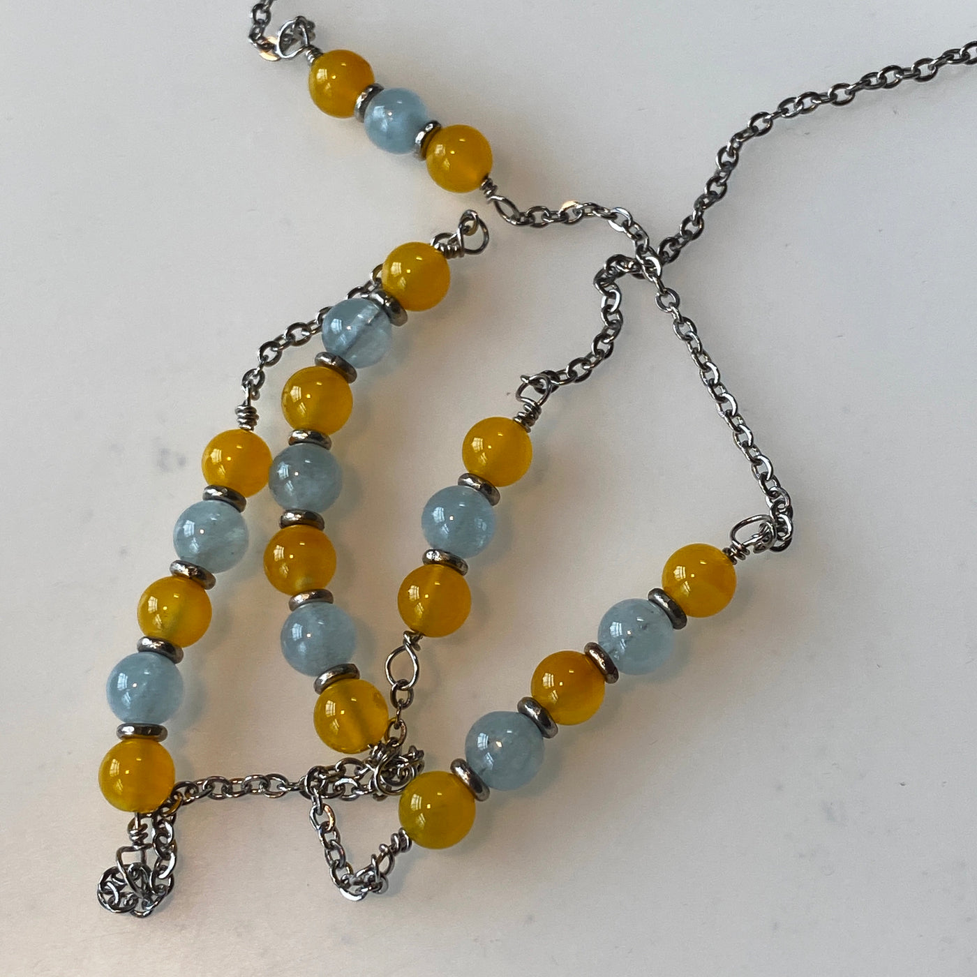 Yellow agate, acquamarine and silver on silver chain necklace. Lines.
