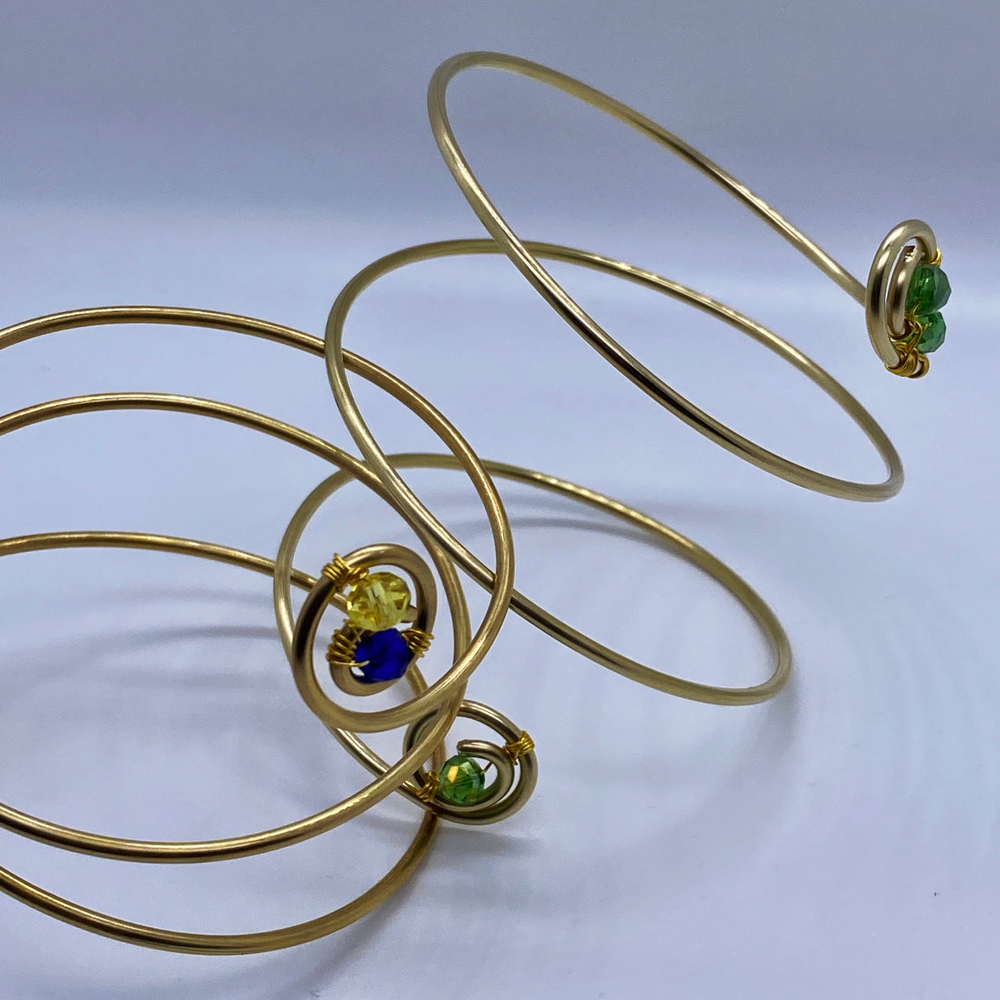 Long spiral brass bracelet with blue crystal rondelles