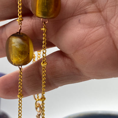 Brass circle texturized necklace on chain with golden glass beads
