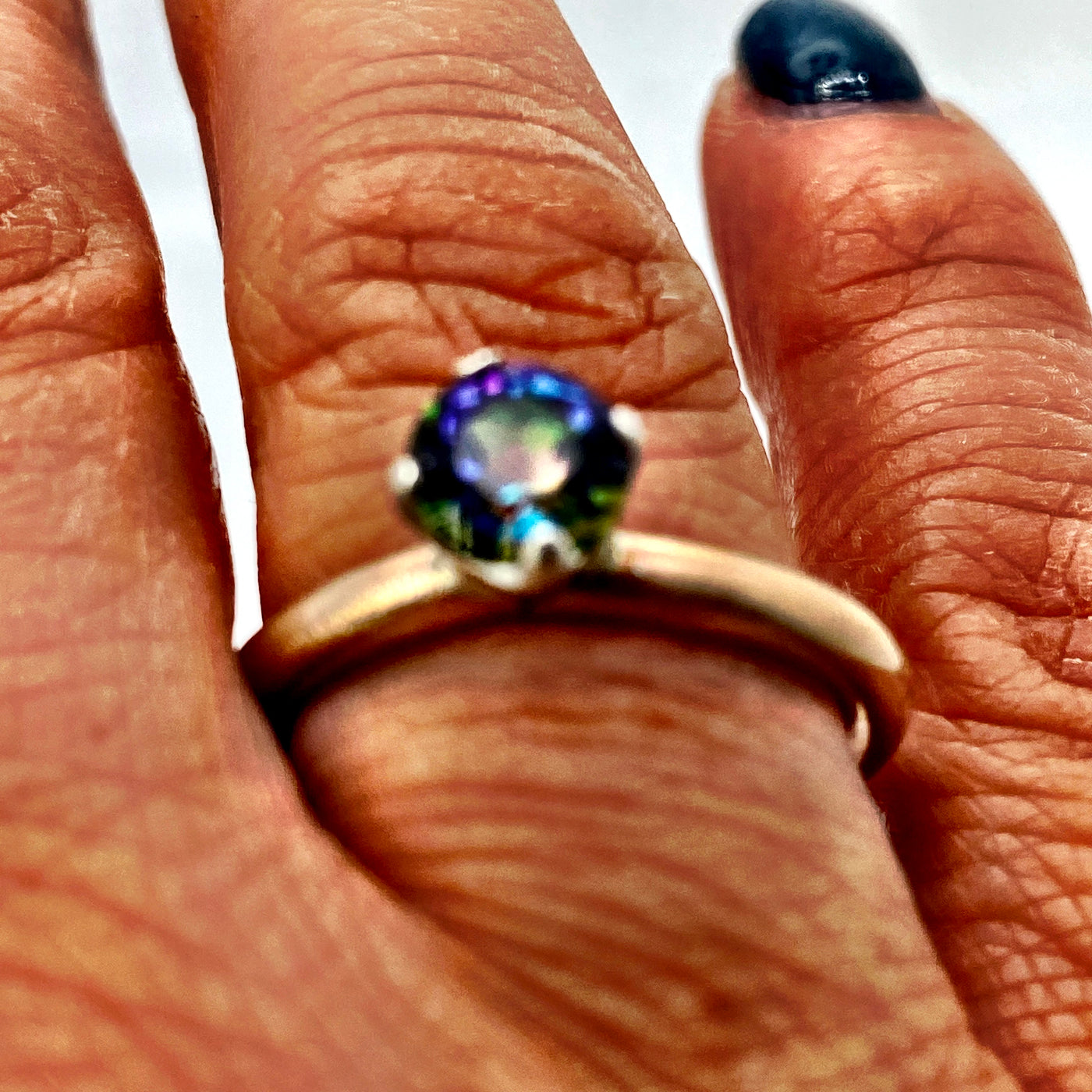 Mystic green topaz ring. This ring is made of brass and silver and features a gorgeous 6mm round mystic green topaz. Size O