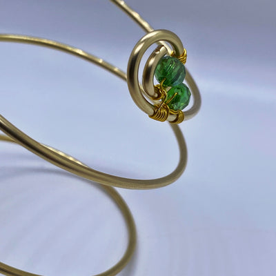 Long spiral brass bracelet with green crystal rondelles