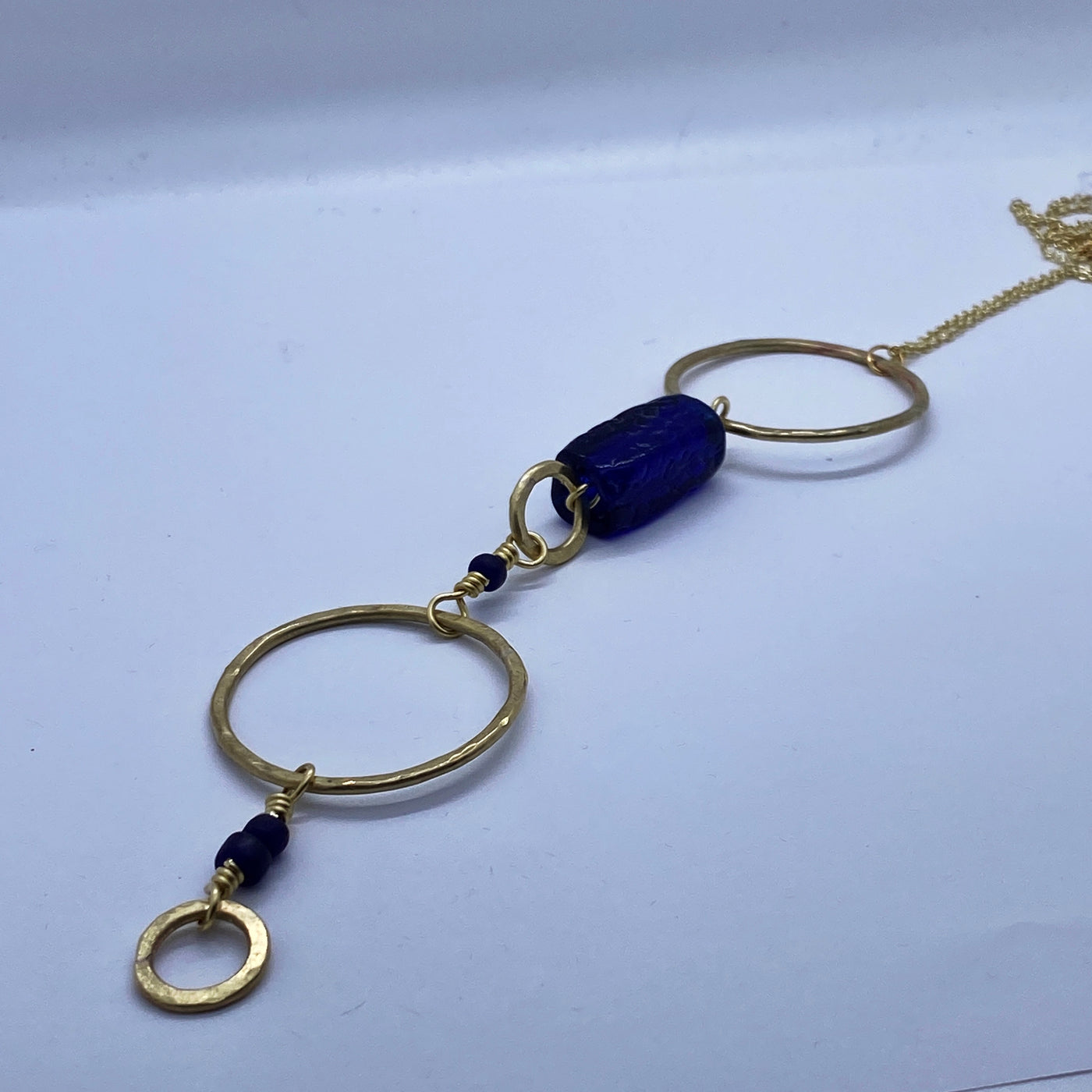 Brass hammered circles with blue glasses necklace