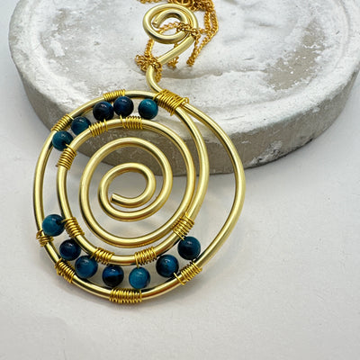 Blue tiger eye and brass round pendant