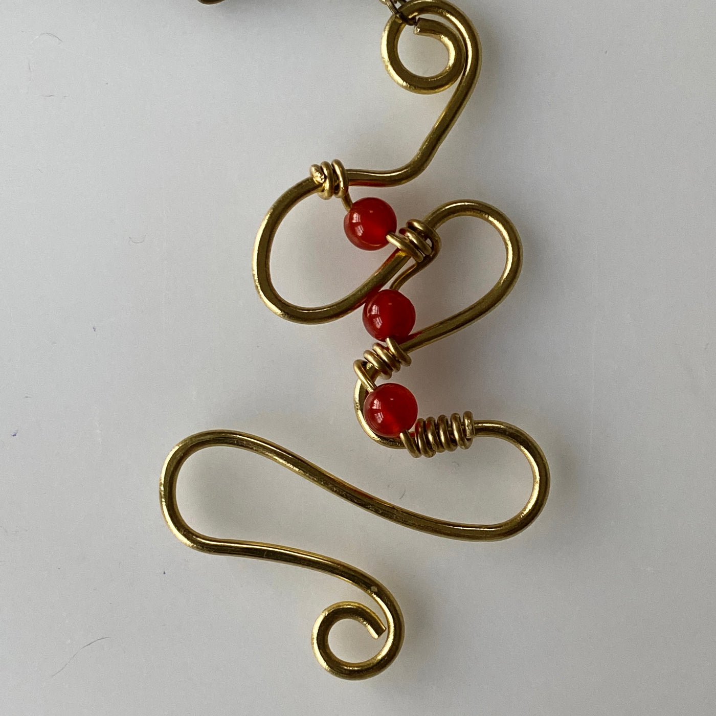 Medium size pendant in brass and red agate on chain. Did you say brass collection.