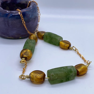 Golden and green glass on chain