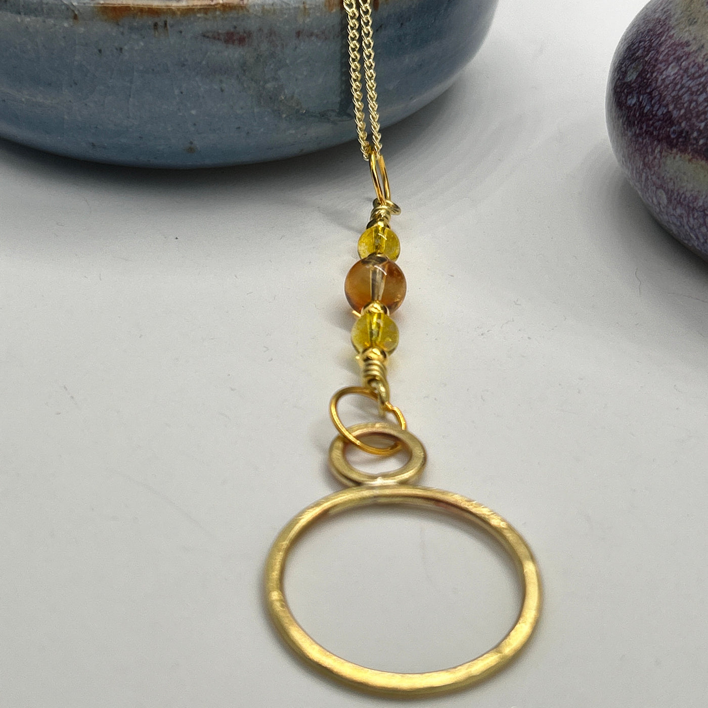 Brass and citrine round pendant. Pendant is 10 cm long and the total necklace lenght is 60 cm