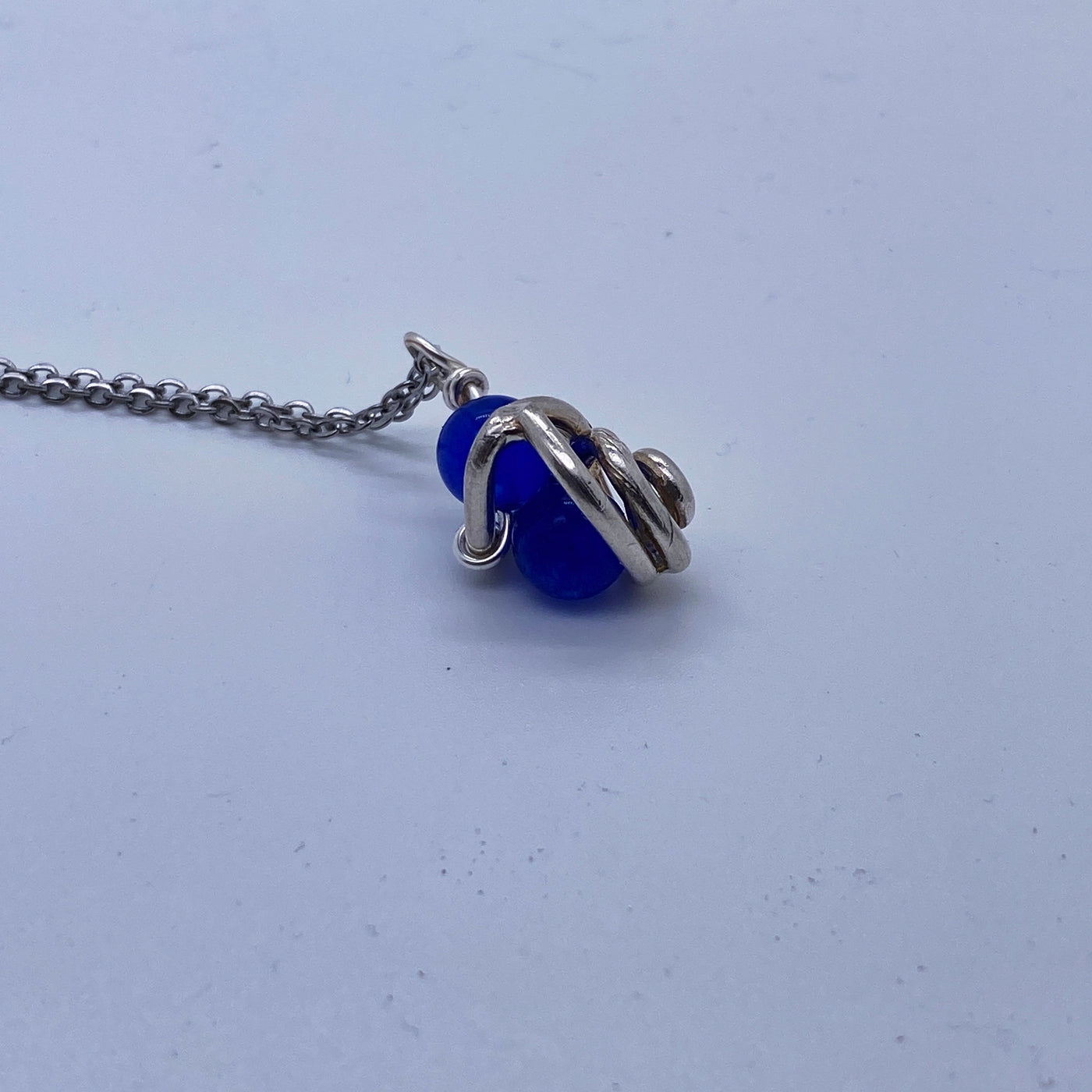 Blue calchedony agate in silver cage