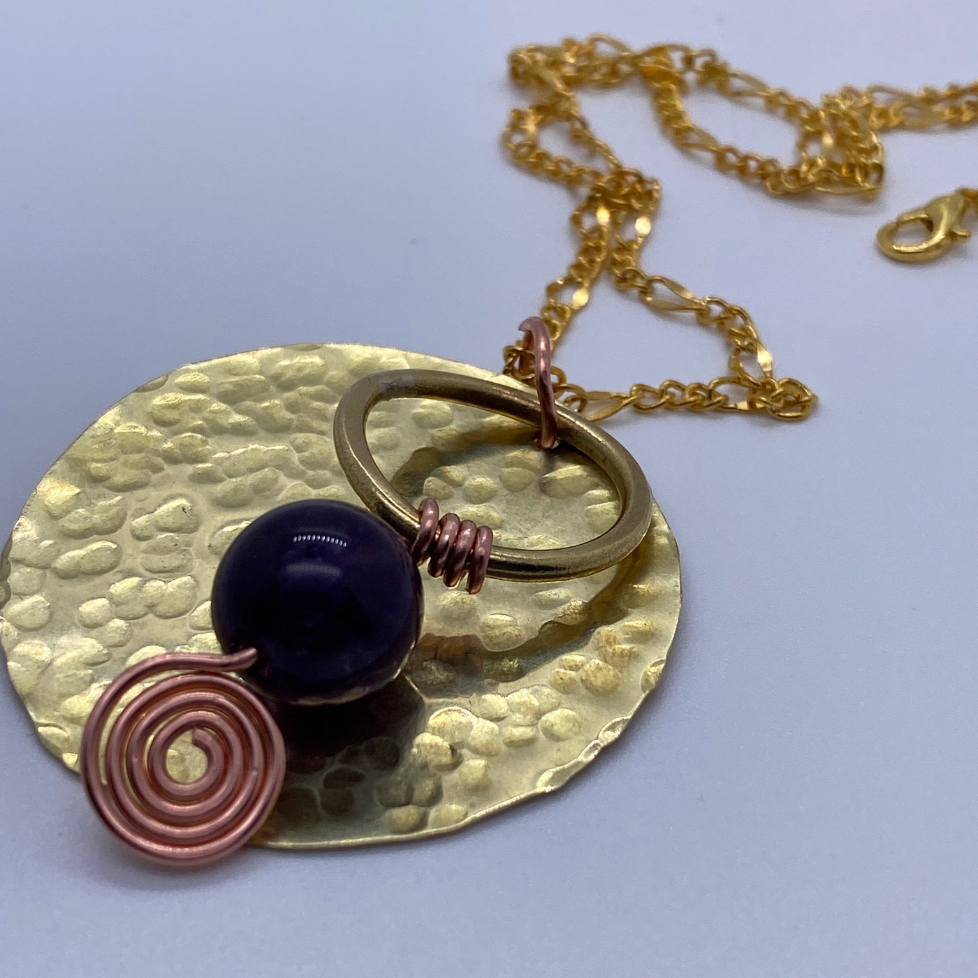 Round full square brass decorated with brass circle, wire and amethyst.