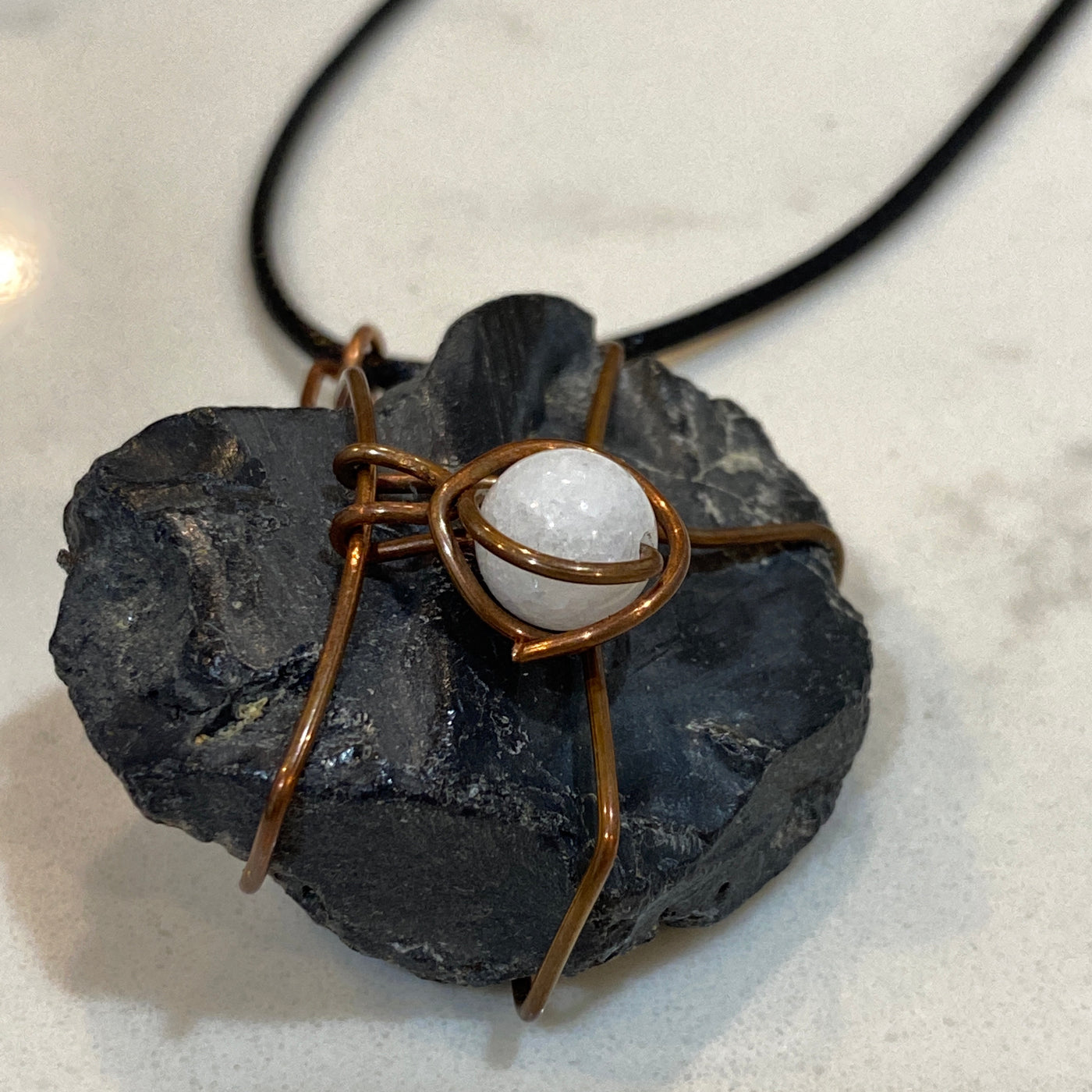 Black stone, white natural stone and wire. Medium pendant. This stone is one of my favourite. It is shiny and has very peculiar shape.